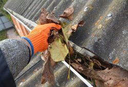 Rain,Gutter,Cleaning,From,Leaves,In,Autumn